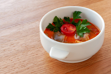 Vegetarian soup Tom Yam with coconut milk, mushrooms and cherry tomatoes.