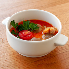 Vegetarian soup Tom Yam with coconut milk, mushrooms and cherry tomatoes. Square format.
