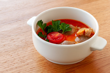 Vegetarian soup Tom Yam with coconut milk, mushrooms and cherry tomatoes.