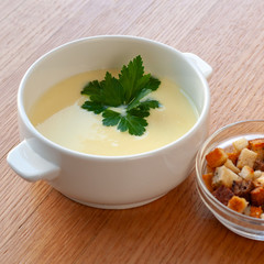 Cheese cream soup with cream, potatoes and spices, decorated with herbs.