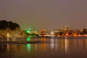 Obraz premium Night view of Turtle Tower or Tortoise tower which is located in the middle of the Hoan Kiem Lake, Hanoi, Vietnam