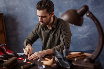 cobber cutting the textile at work, close up photo
