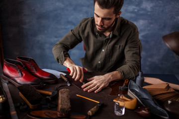 crafsman working with a special knife at workshop, master class