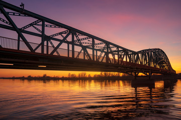 iron truss bridge at sunset