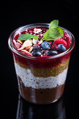 Homemade layered dessert with fresh fruits and chia seeds