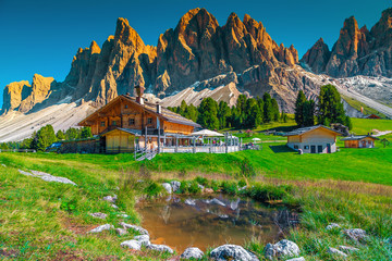 Cozy alpine chalets with mountain lake in Dolomites, Italy, Europe