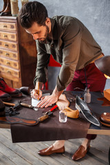 young man is interested in shoe design, student learning the basics of shoe design . side view close up photo