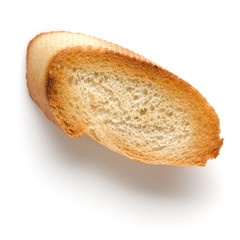 Toasted baguette slice isolated on white background close up.  Toast, crouton.   Top view.