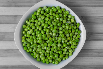 Freshly cooked green peas served in dish.