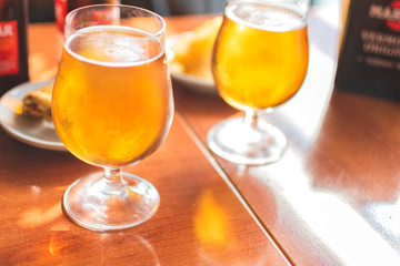 Glasses of cold beer with delicious tapas.