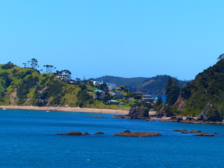 photo picture of a beautiful sea and ocean view with a natural background of rocks, forests and mountains