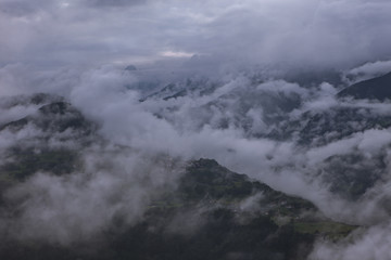 Fototapeta premium Clouds moving along the mountains on a cloudy day