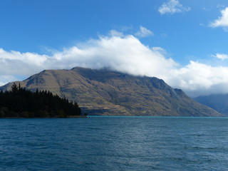 photo picture of a beautiful sea and ocean view with a natural background of rocks, forests and mountains