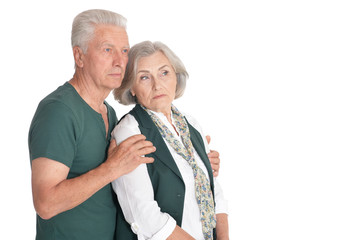 Portrait of thinking senior couple on white background