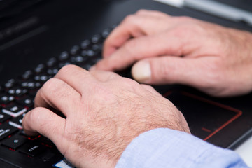 male hands are pressing the keyboard
