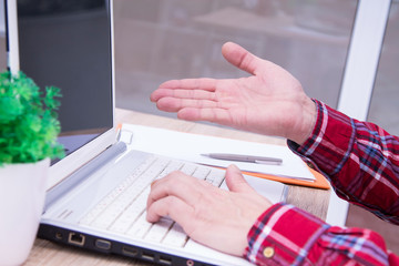 hands on the keyboard and palm raised