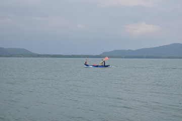 A small fishing boat is in the sea alone.