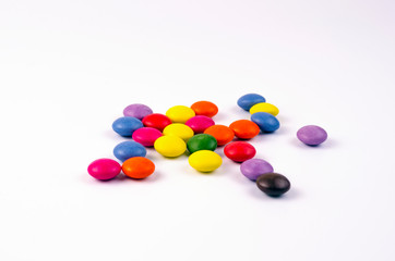 Multicolored chocolate sweets on a white background
