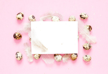 Fototapeta na wymiar Blank greeting card. Easter composition with easter eggs and feathering on pink background. Image