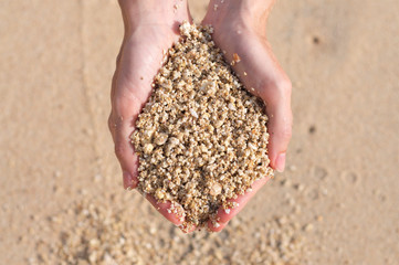 Sand heap hold in woman's hands