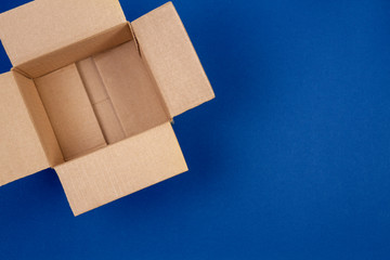 Open empty cardboard boxes on blue background