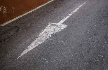 Direction arrow on the asphalt, road sign for vehicles