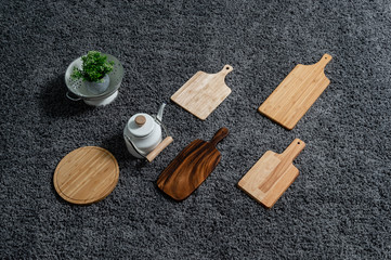 Various kinds of kitchen tools on the grey carpet.