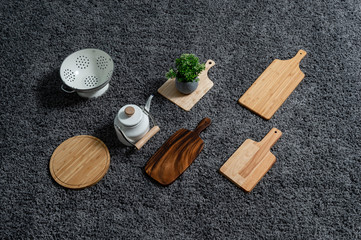 Various kinds of kitchen tools on the grey carpet.