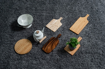 Various kinds of kitchen tools on the grey carpet.