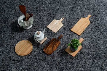 Various kinds of kitchen tools on the grey carpet.