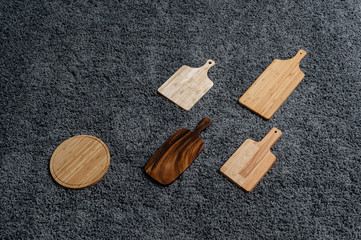 Various kinds of kitchen tools on the grey carpet.