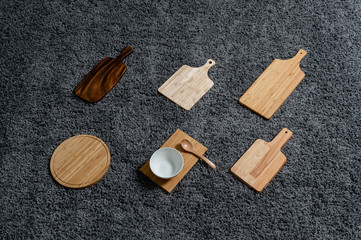 Various kinds of kitchen tools on the grey carpet.