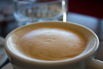 white cup with latte coffee macro, foam