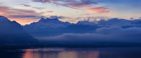 Fototapeta na wymiar Beautiful view on the side of Geneva lake, with the peaks Dents du Midi of Swiss Alps in background, Montreux, Canton of Vaud, Switzerland Alps on Lake Geneva at Vevey, Switzerland