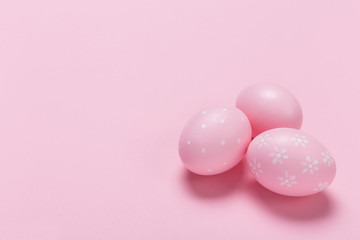 Pink easter eggs in nest on pastel color background with space. Concept