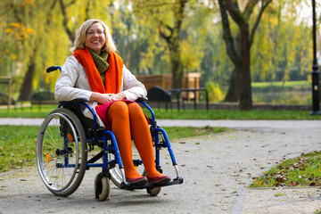 happy young adult woman on wheelchair