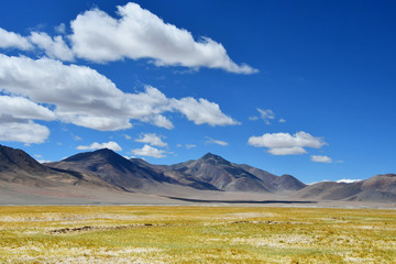 China, Tibetan plateau. Big clouds over the TRANS-Himalayas on the way from Ringtor to Yakra in June in sunny day