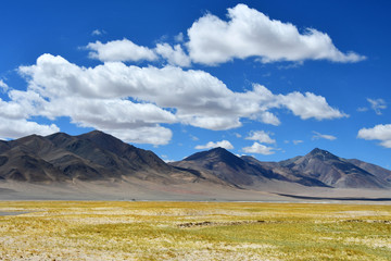 China, Tibetan plateau. Big clouds over the TRANS-Himalayas on the way from Ringtor to Yakra in June in sunny day