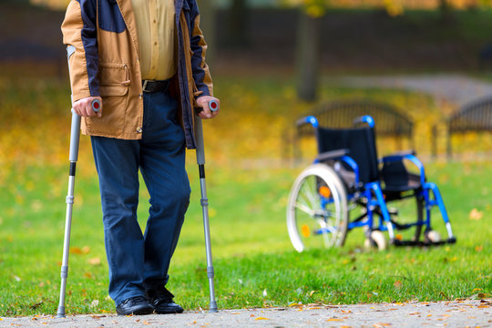 Older Man Practicing Walking On Crutches