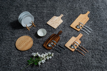Various kinds of kitchen tools on the grey carpet.