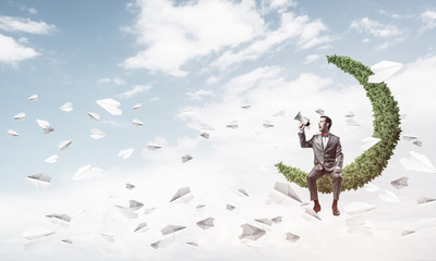 Businessman announcing something in loudspeaker and paper planes fly around
