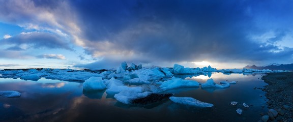 Sunrise in Jokulsarlon. Icelandic ice lagoon of jokulsarlon in the morning in summer or winter. Blue icebergs floating in Jokulsarlon Glacier Lagoon, early winter in south Iceland. Most popular place