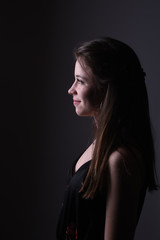 young brunette woman on black background