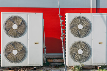 Air conditioners or HVAC or climate control systems on backyard of building