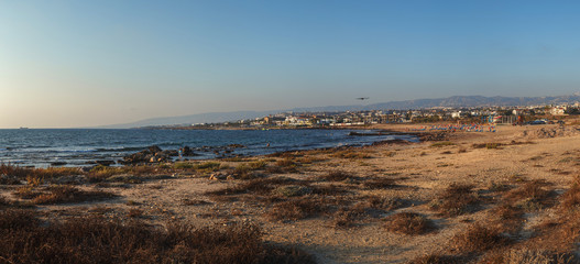 Paphos's smooth shore.Dry grass and stones around.