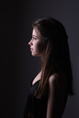 young brunette woman on black background