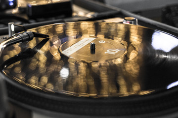 Vinyl record player. DJ mixing console. Needle on the music track. Sound recording studio. Party...