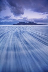 Beautiful, dreamy sky and the sea in Scotland Waves crossing on shoreline with moody dramatic sky on the Isle of Skye, Scotland, UK The place is in Isles in north atlantic ocean travel