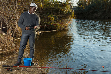 Man standing with fishing rod