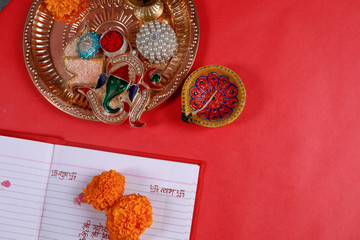 calligraphy writing in hindi Shubha Labh means Goodness & Wealth, over Red accounting note book ,...